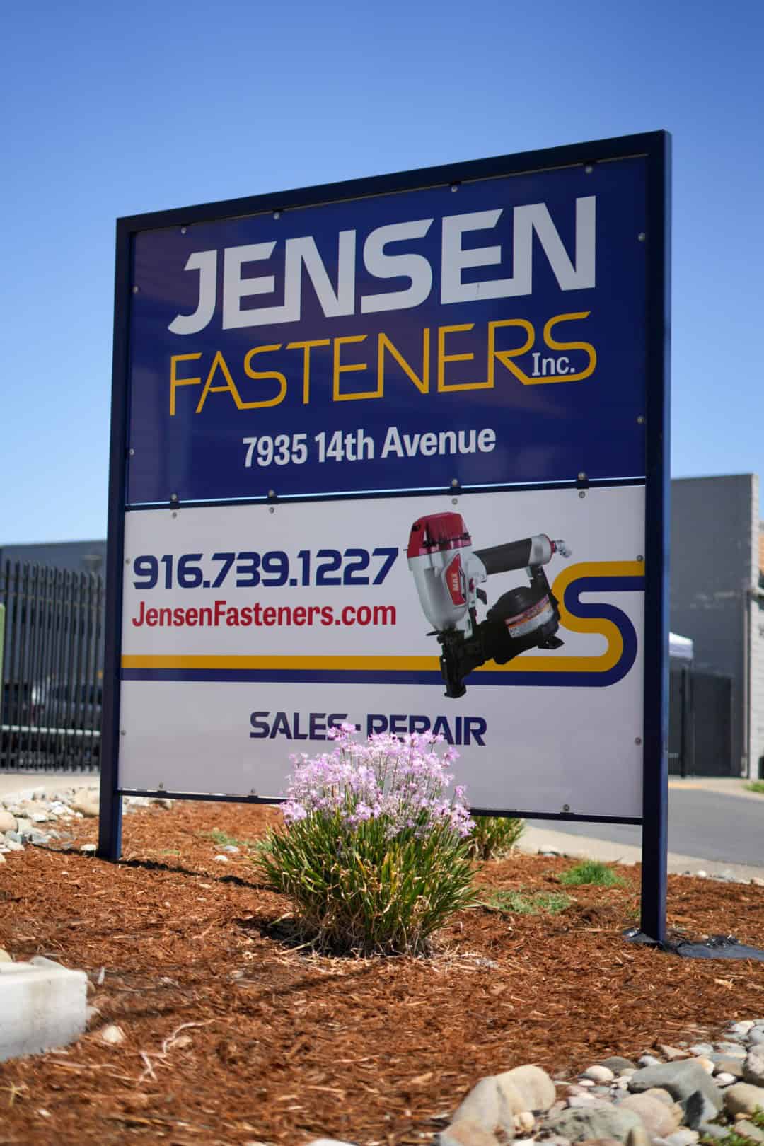 Sign for Jensen Fasteners Inc., displaying contact info, website, and services for sales and repair, located at 7935 14th Avenue.